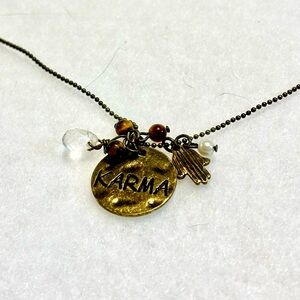 Karma Antique Brass Multi Pendant Necklace by Claire’s